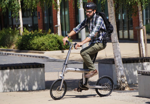 Rider on the FLIT M2i folding e-bike in an urban street. Image credit: FLIT